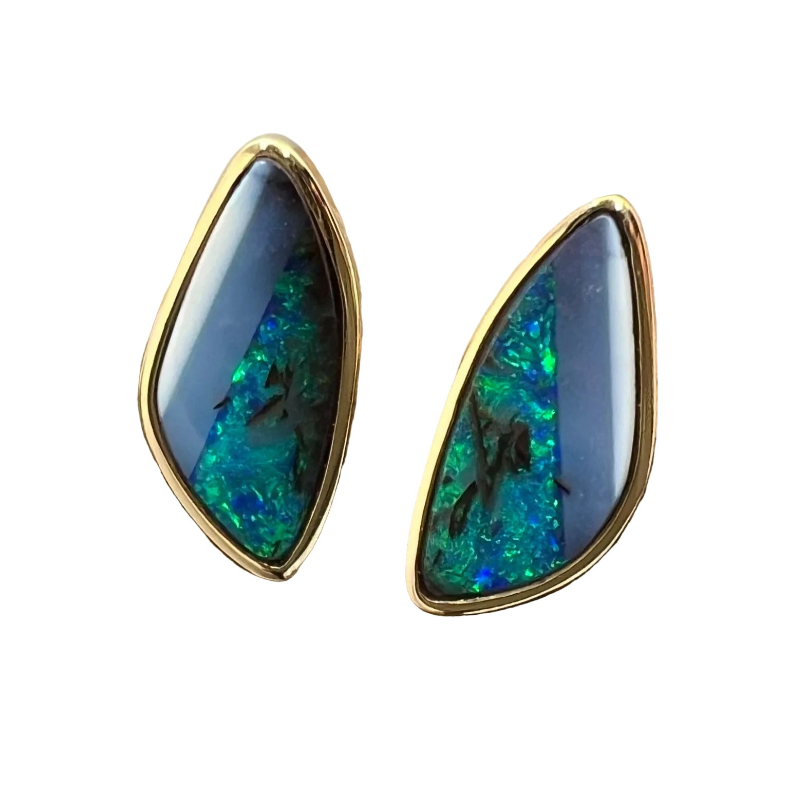 A pair of 14K gold bezel-set boulder opal earrings displayed on a wooden white background.