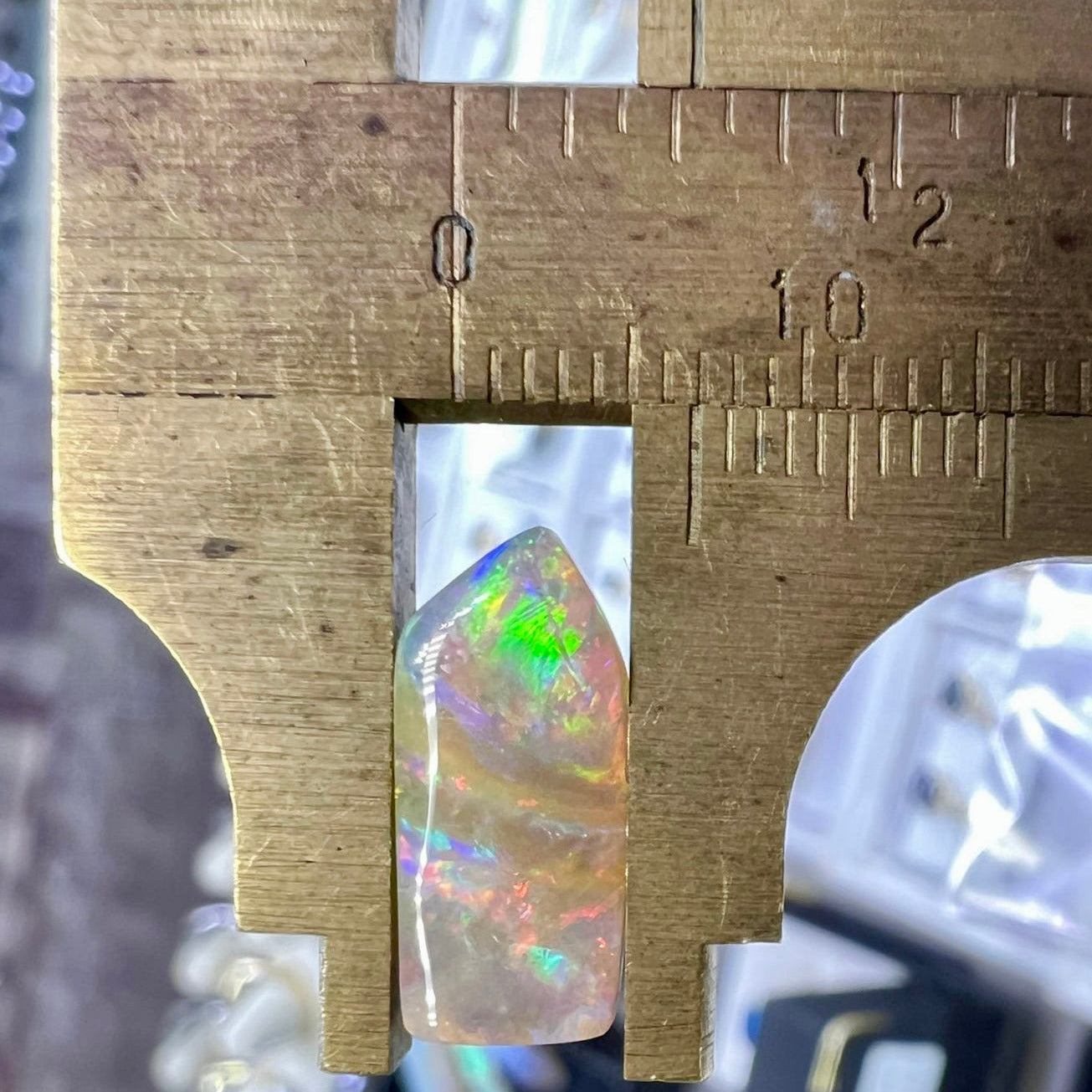 Opal stone with a ruler showing its size