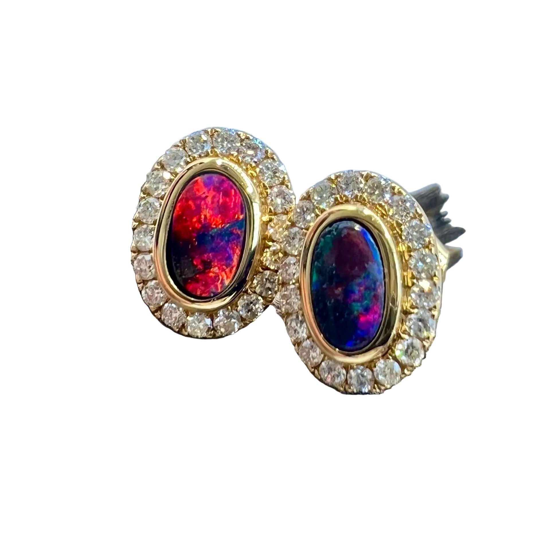 Fiery red opals in a beautiful pair of yellow gold earring studs with a feature being the halo of diamonds claw set around the oval shaped design.