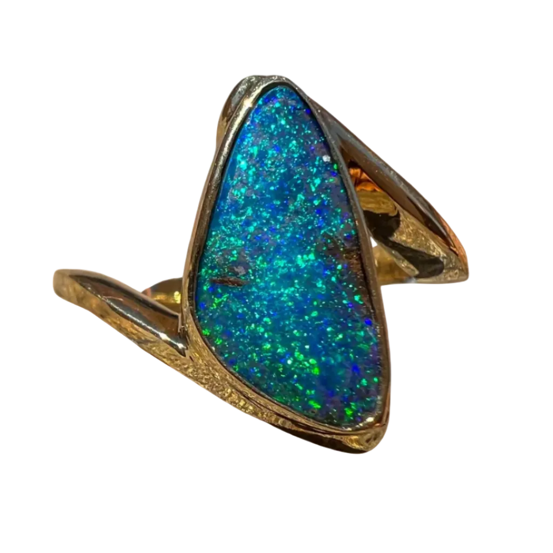 Ring with a blue and green opal stone on a brown background