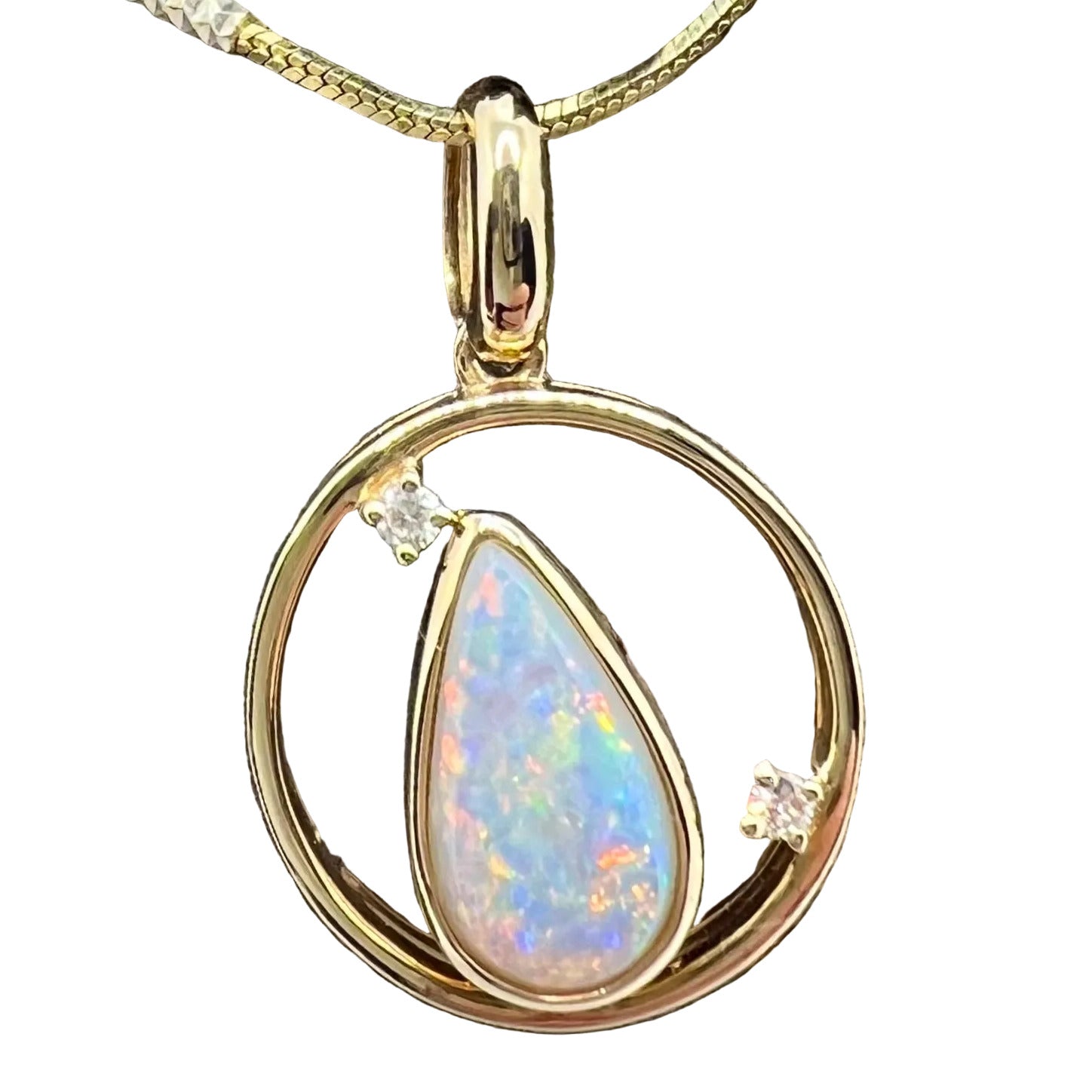 A 9K gold pendant featuring a white opal centerpiece surrounded by a circle of smaller opals, set on a textured wooden surface.