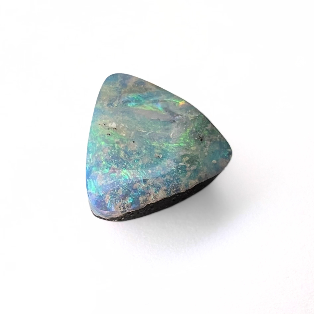 Triangular opal stone on a white background