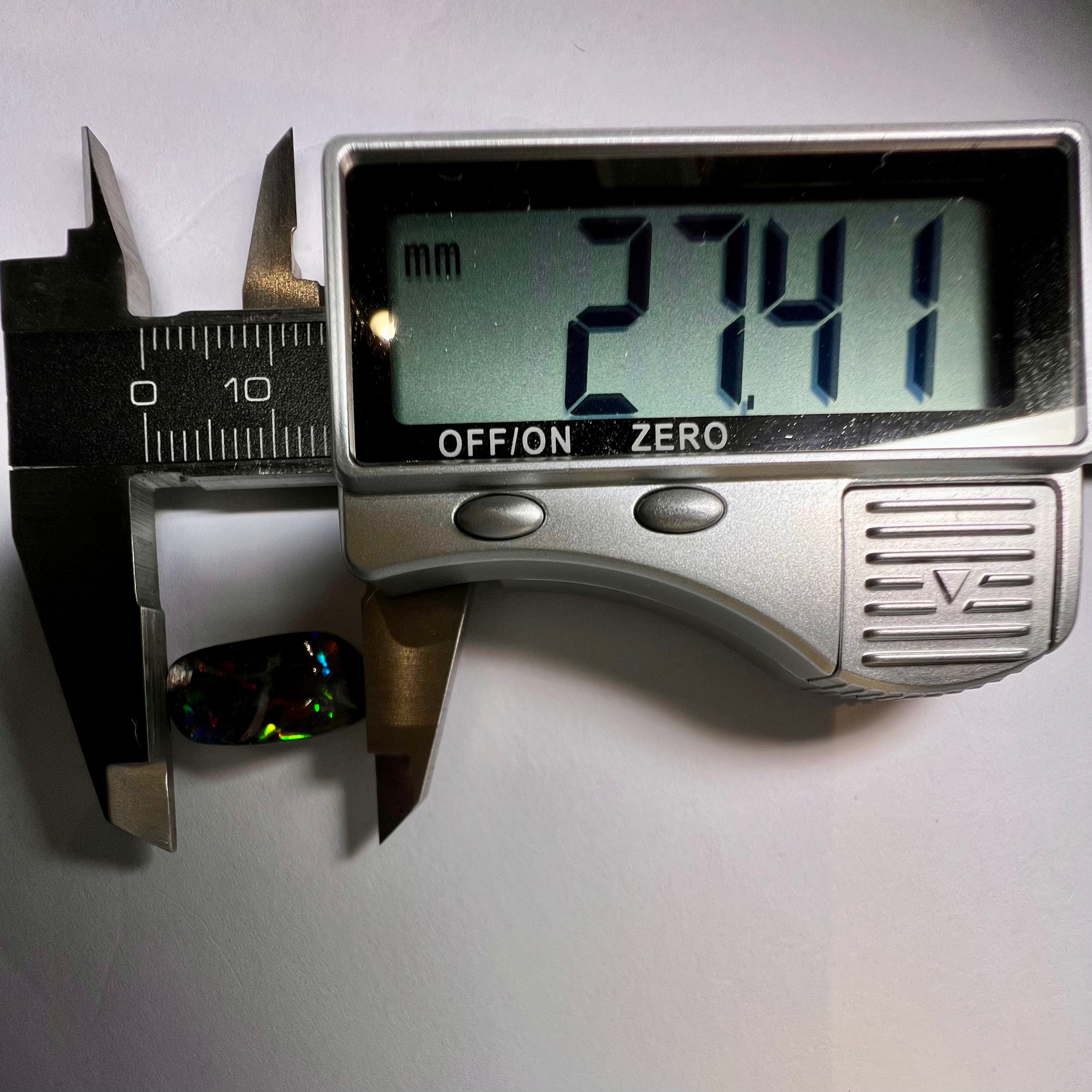 Digital caliper measuring a stone with a displayed measurement of 27.41mm on a white background.