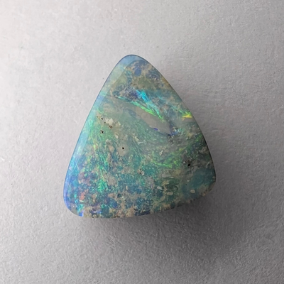 Colourful pale blue, green and pink bright opal. Triangular shaped cut, bright pattern and play of colour. 